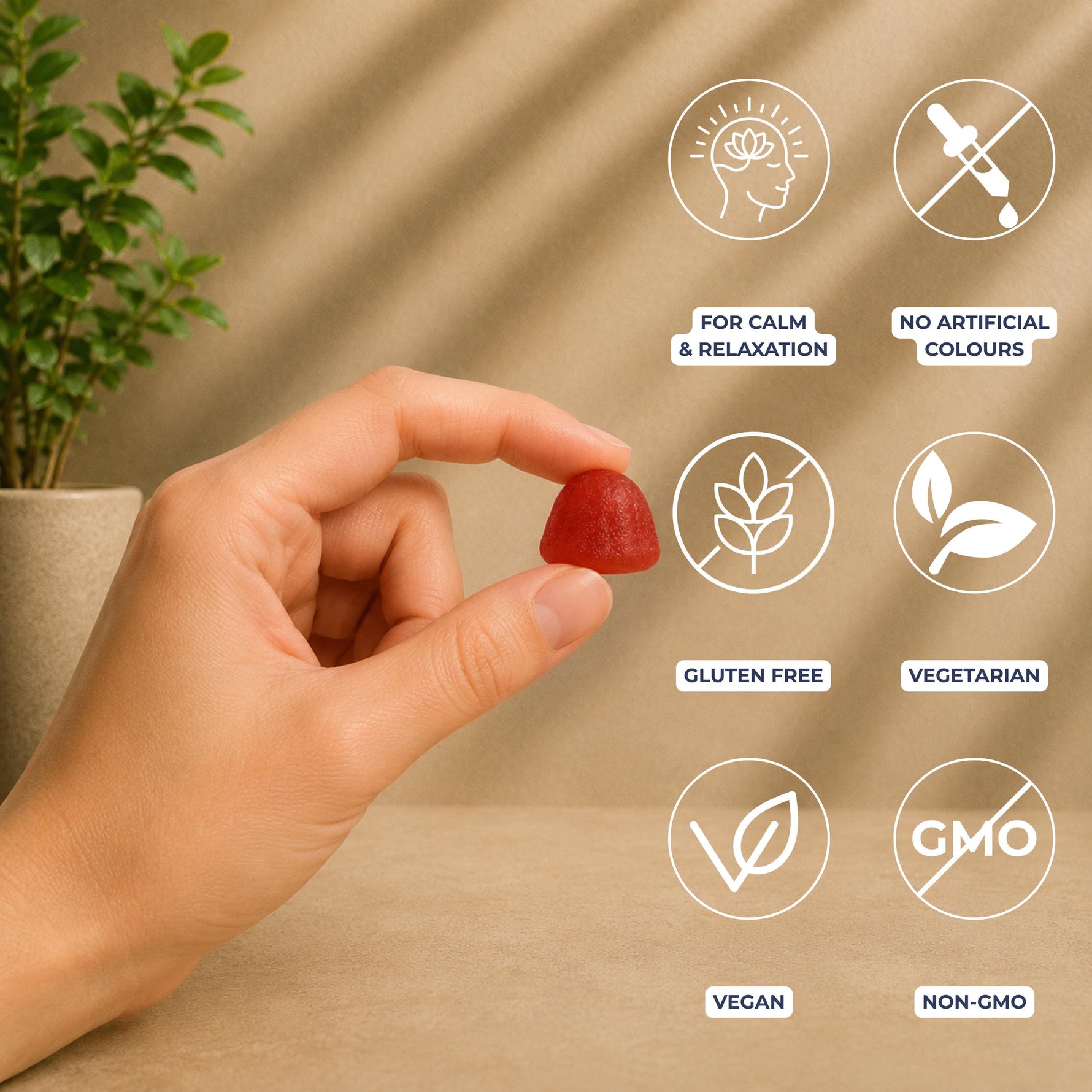A hand holds a small red gummy against a warm beige background with soft leaf shadows. White circular icons with dark blue text highlight product benefits: for calm & relaxation ; no artificial colours; gluten free; vegetarian; vegan; and non-GMO